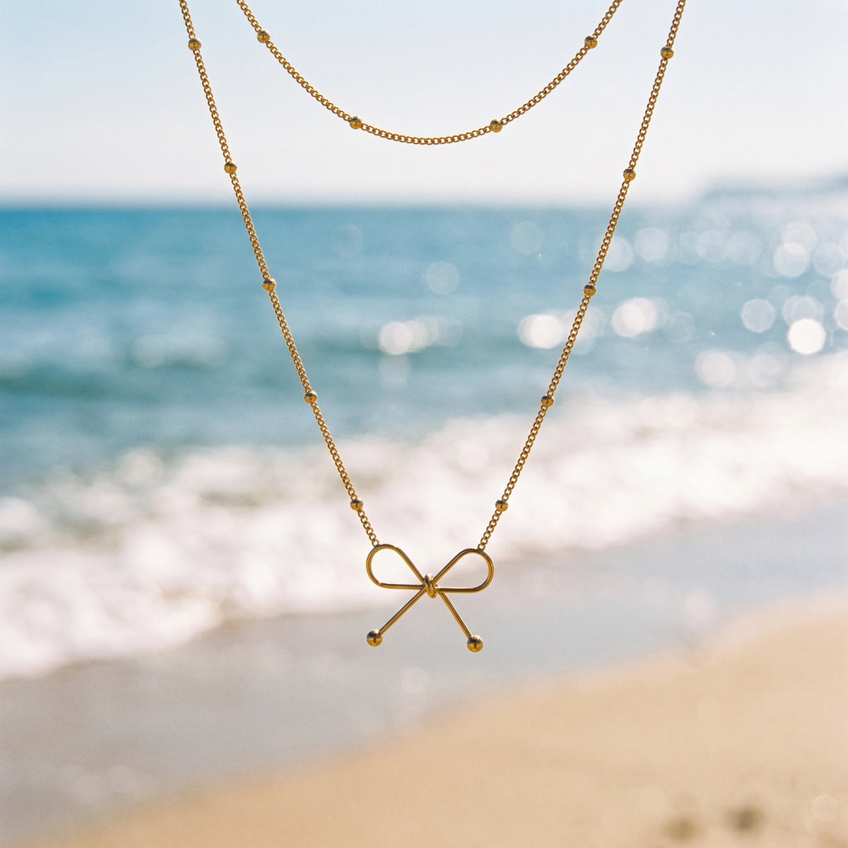 QIAOREN 13985 Beaded Oval Link Chain Pendant Necklace with Hollow Line Bow Charm, Polished Gold Minimalist Bow Collar